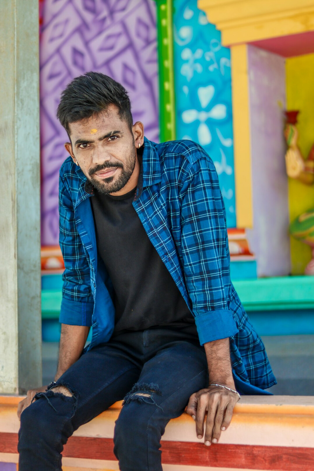 Portrait of a young man with short beard in casual shirt
